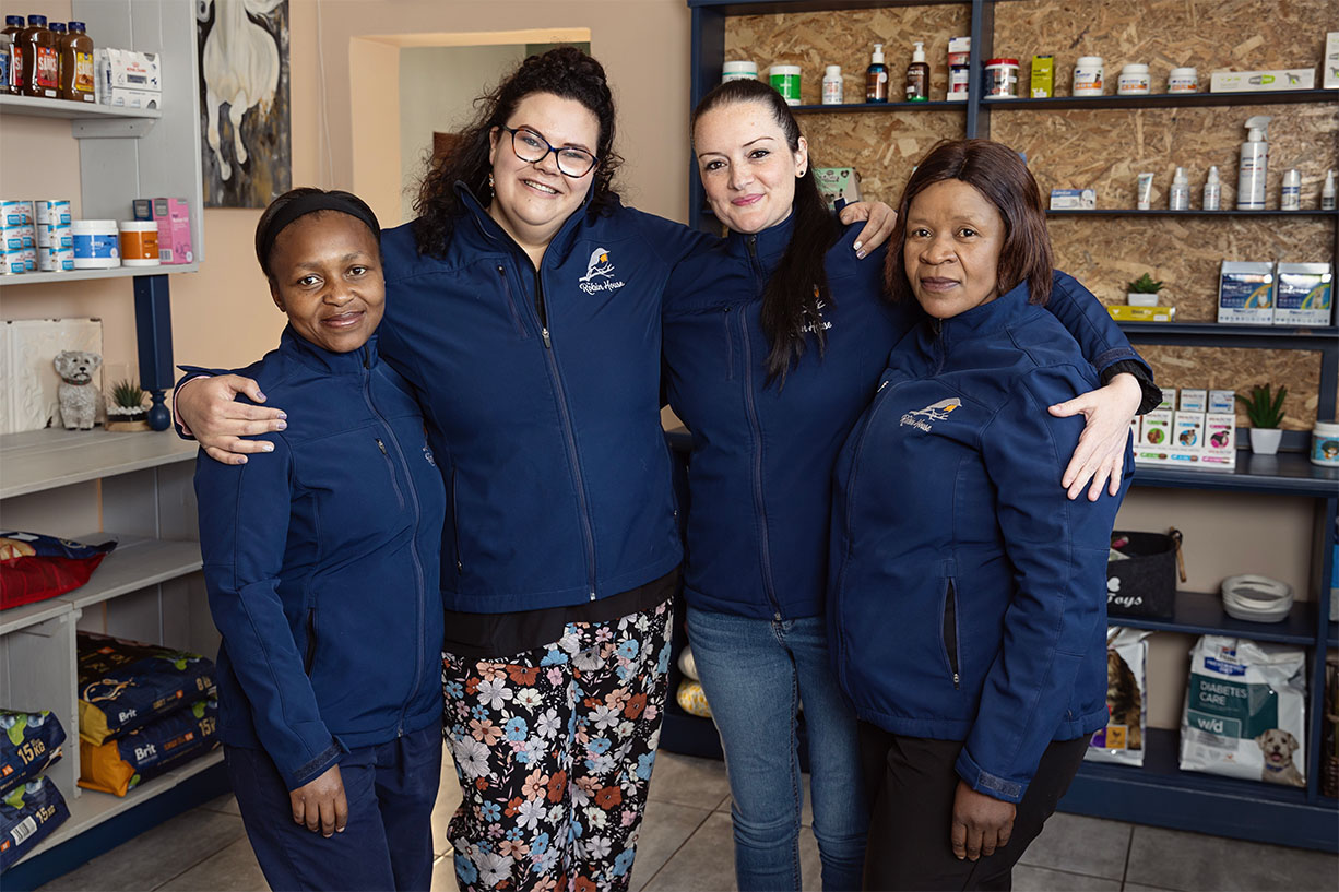 The dedicated and friendly boarding care team standing together in the vet shop at The Robin House boutique cat hotel in Benoni.