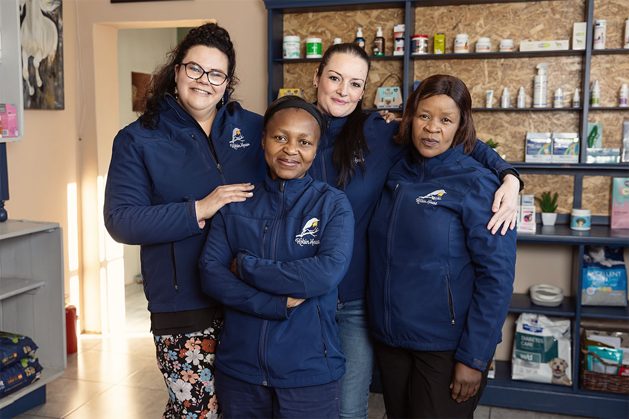 Dr. Leigh, Kim, Julia, and Mavis smiling together, representing the dedicated boarding care team at the dog hotel in Johannesburg.