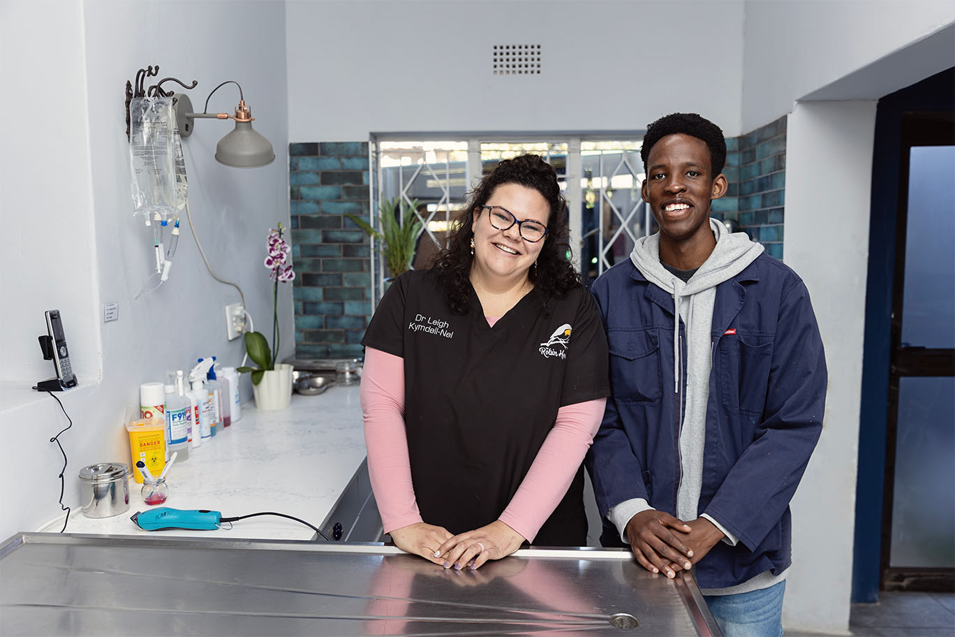 Veterinary Director Dr. Leigh and assistant Kwena smiling in the medical treatment area of The Robin House hospital in Benoni.